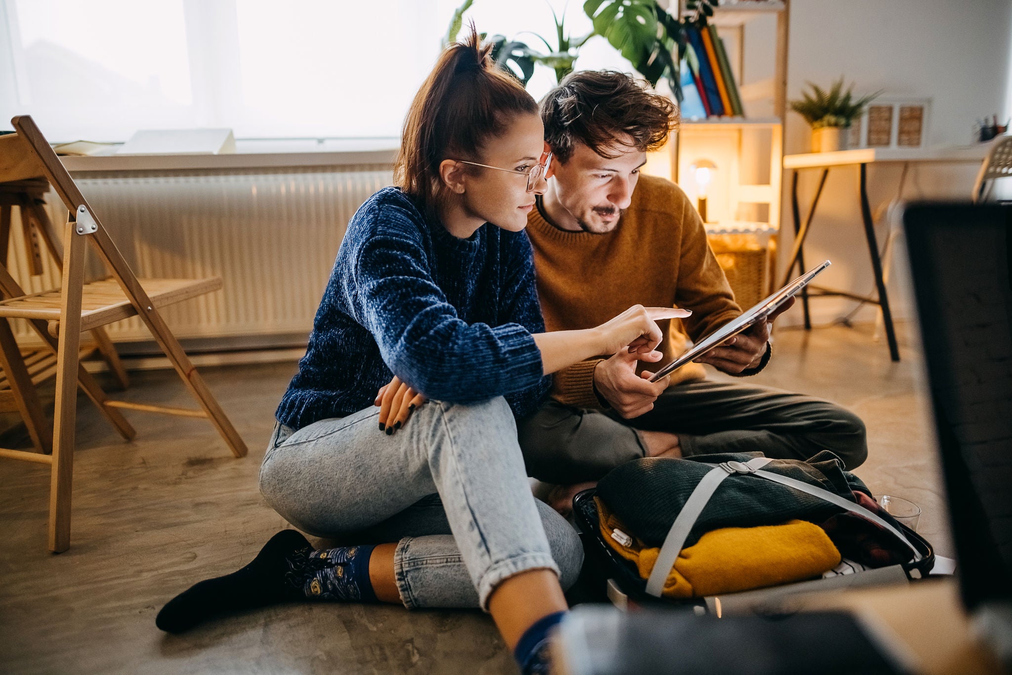 Couple planning vacation trip and searching information on tablet